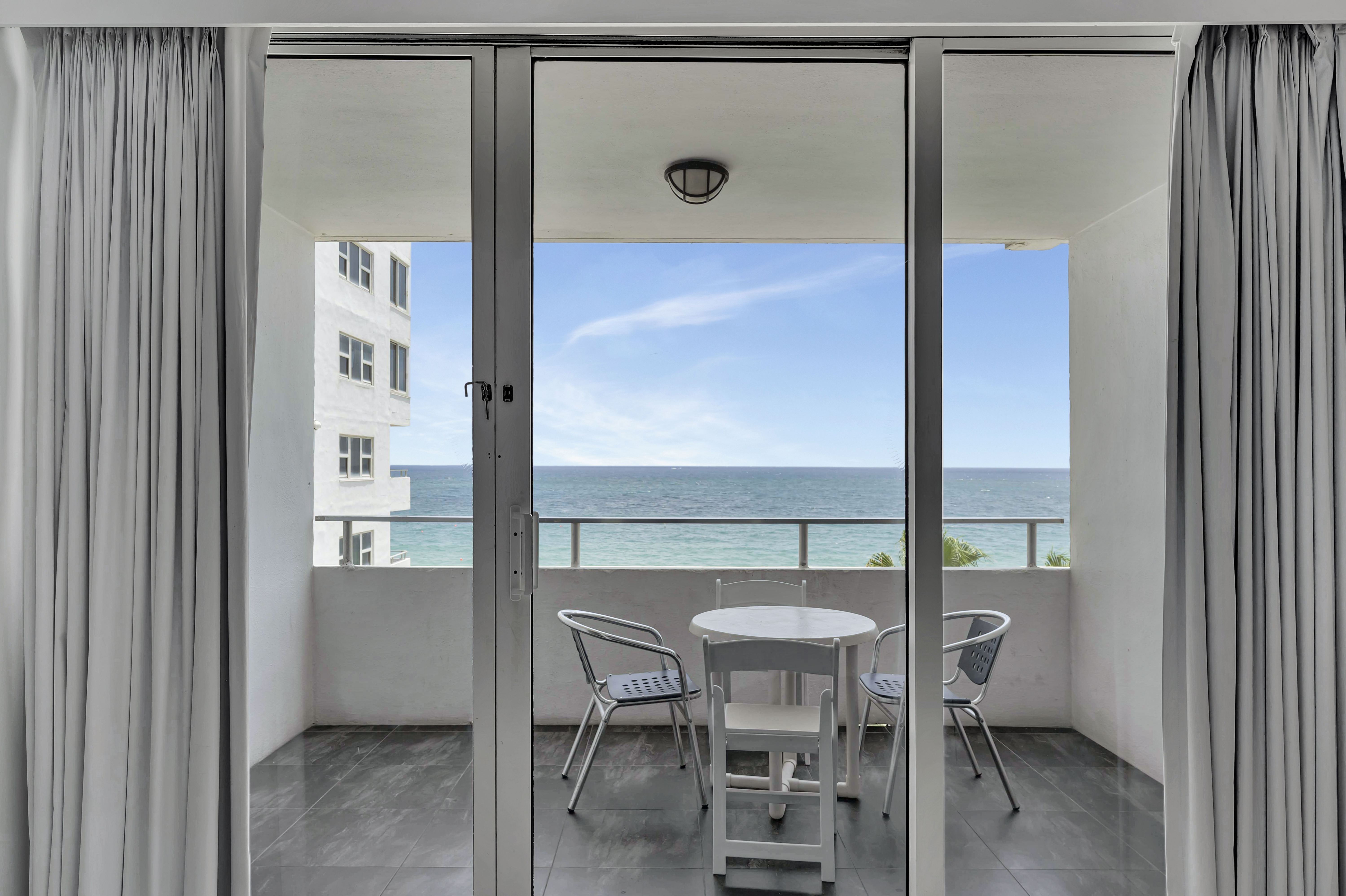 1 Bedroom Suite interior view towards private balcony and ocean beyond
