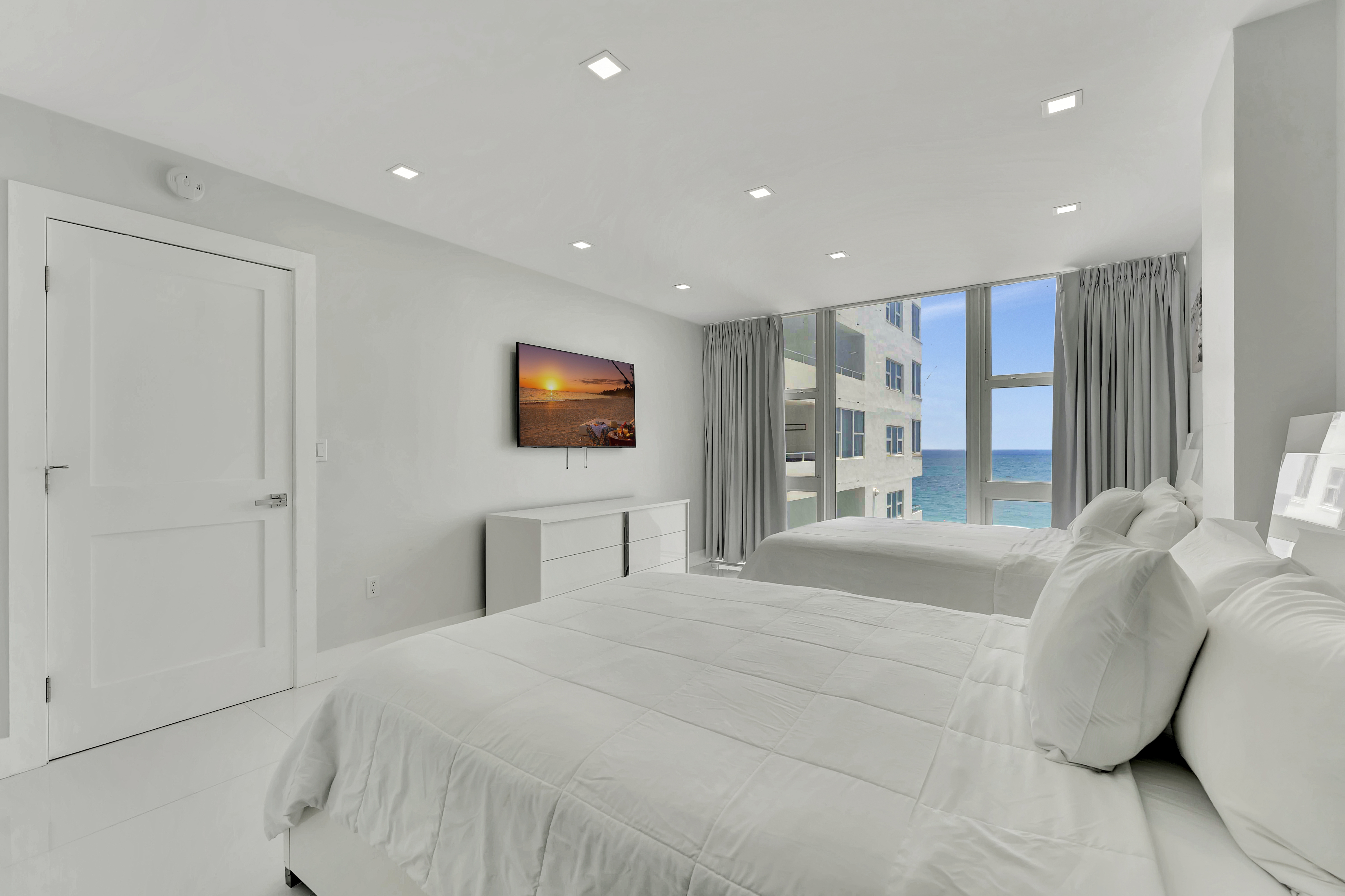 1 Bedroom Suite master bedroom with ocean views and entertainment center