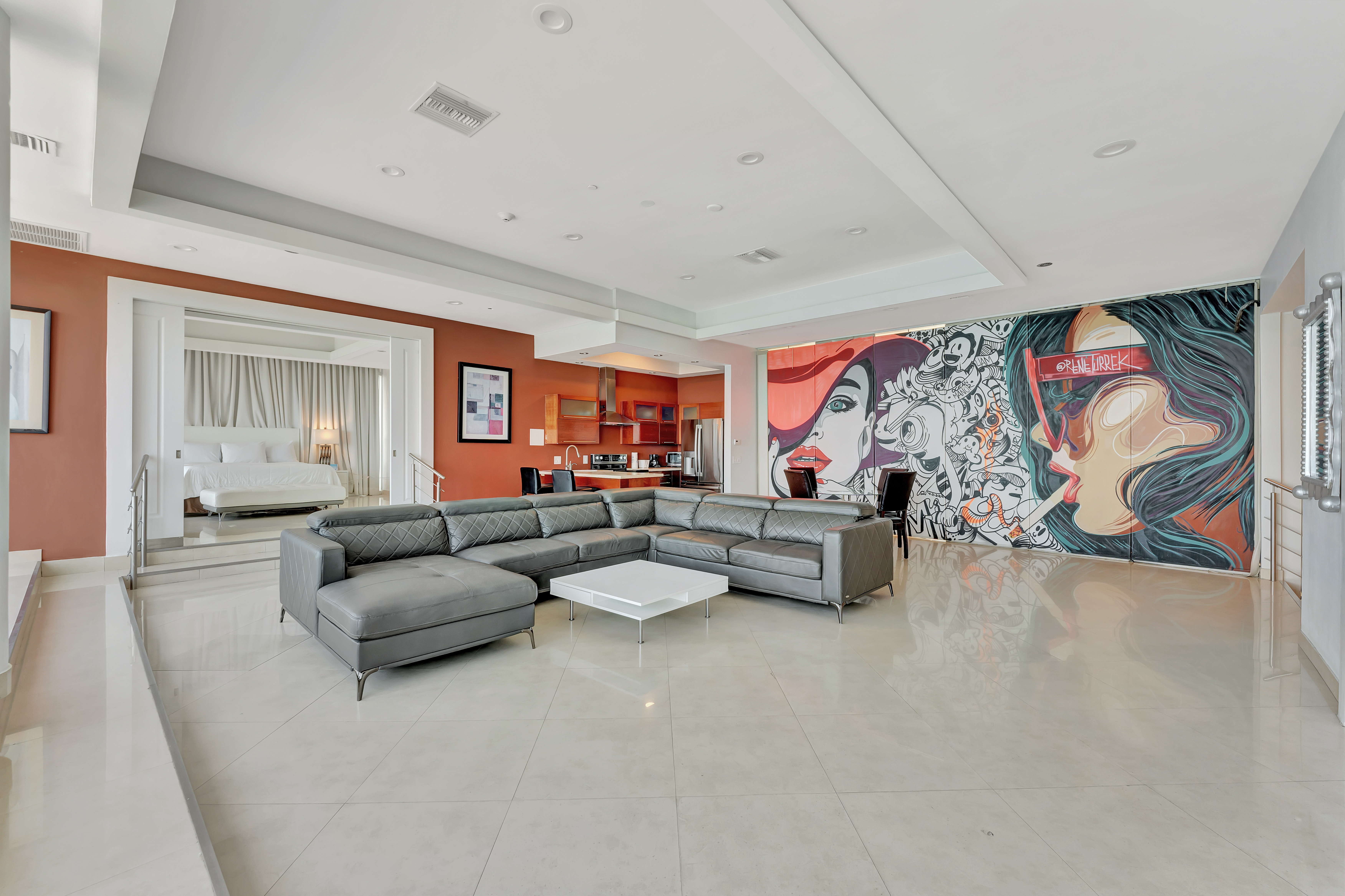 Full Interior View of Ocean Manor Penthouse 1002 Featuring Master Bedroom, Living Room, Kitchen, and Art Mural