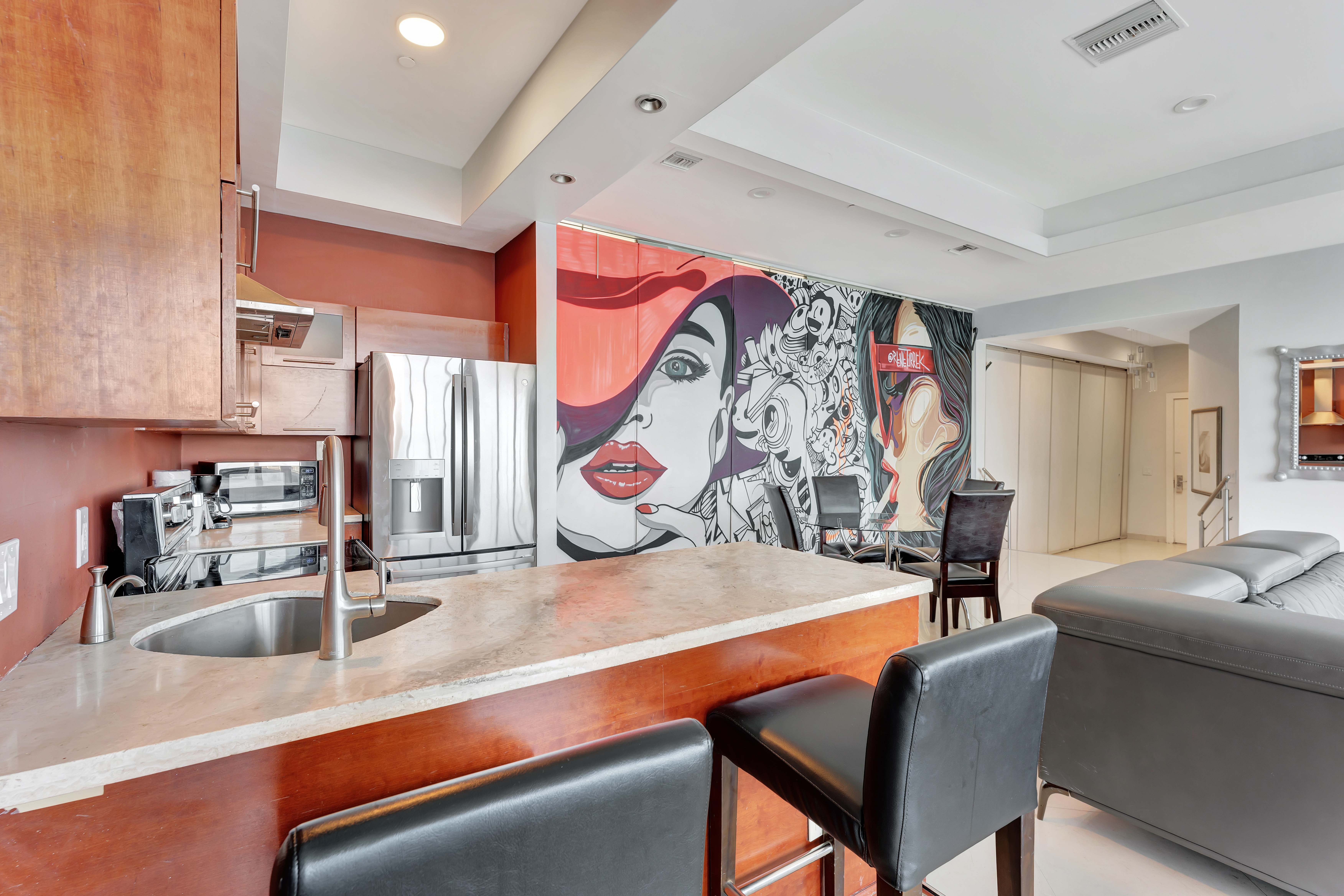 Kitchen and Bar Area in Ocean Manor Penthouse 1002 with Artistic Mural and Modern Design