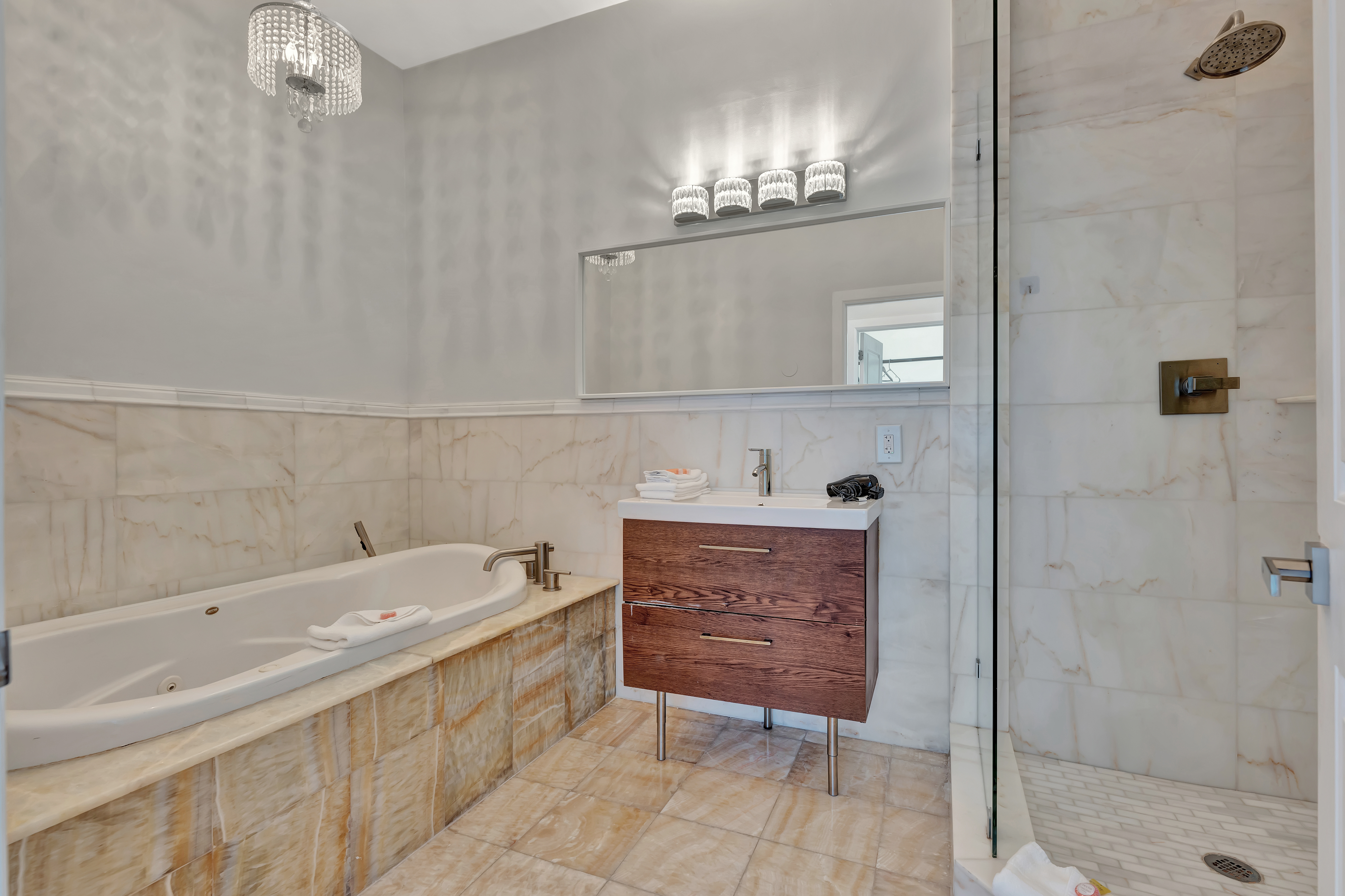 Master Bathroom in Ocean Manor Penthouse 1002 with Soaking Tub, Marble Shower, and Modern Vanity