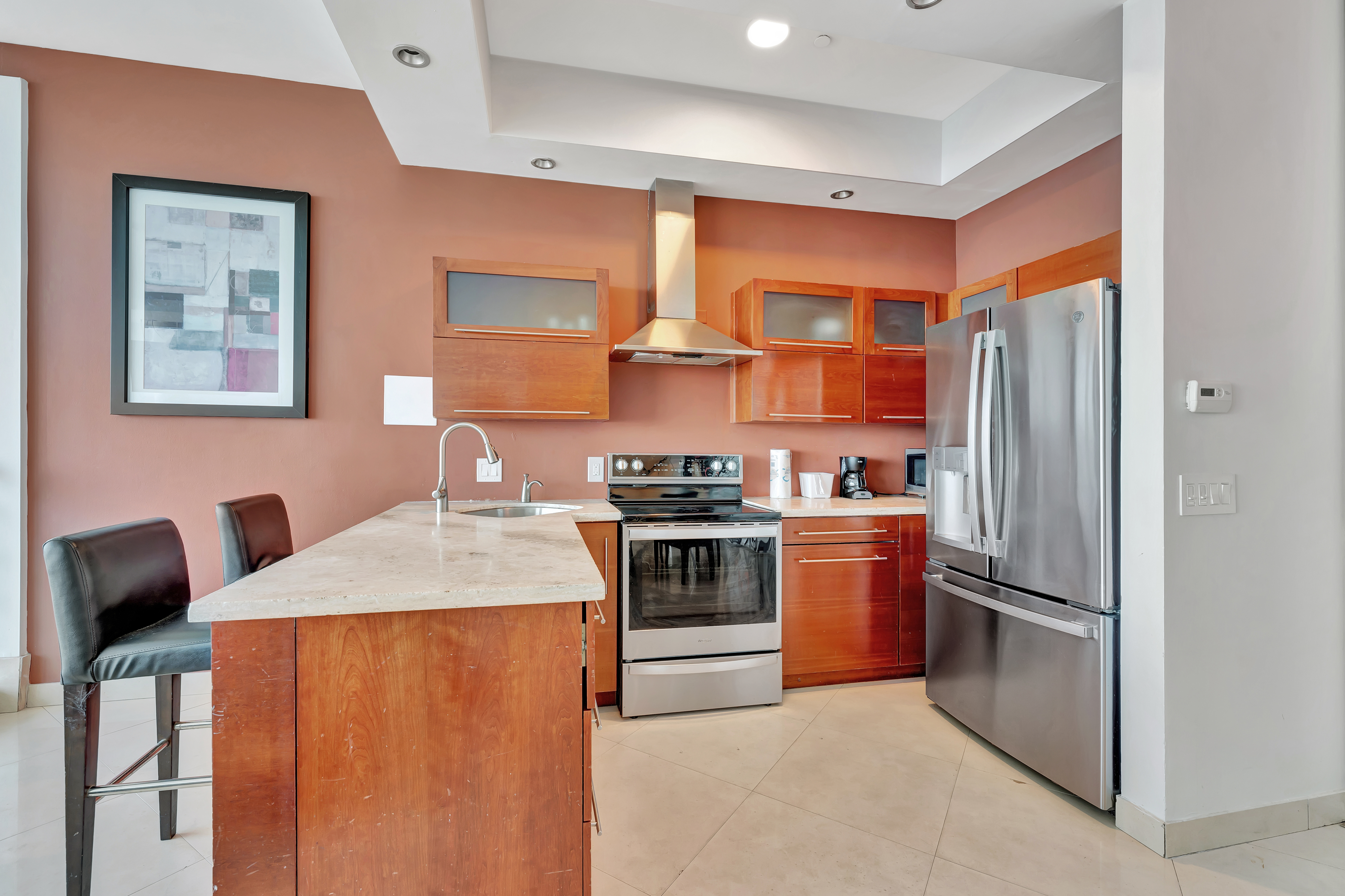 Modern Kitchen in Ocean Manor Penthouse 1002 with Stainless Steel Appliances and Contemporary Cabinets