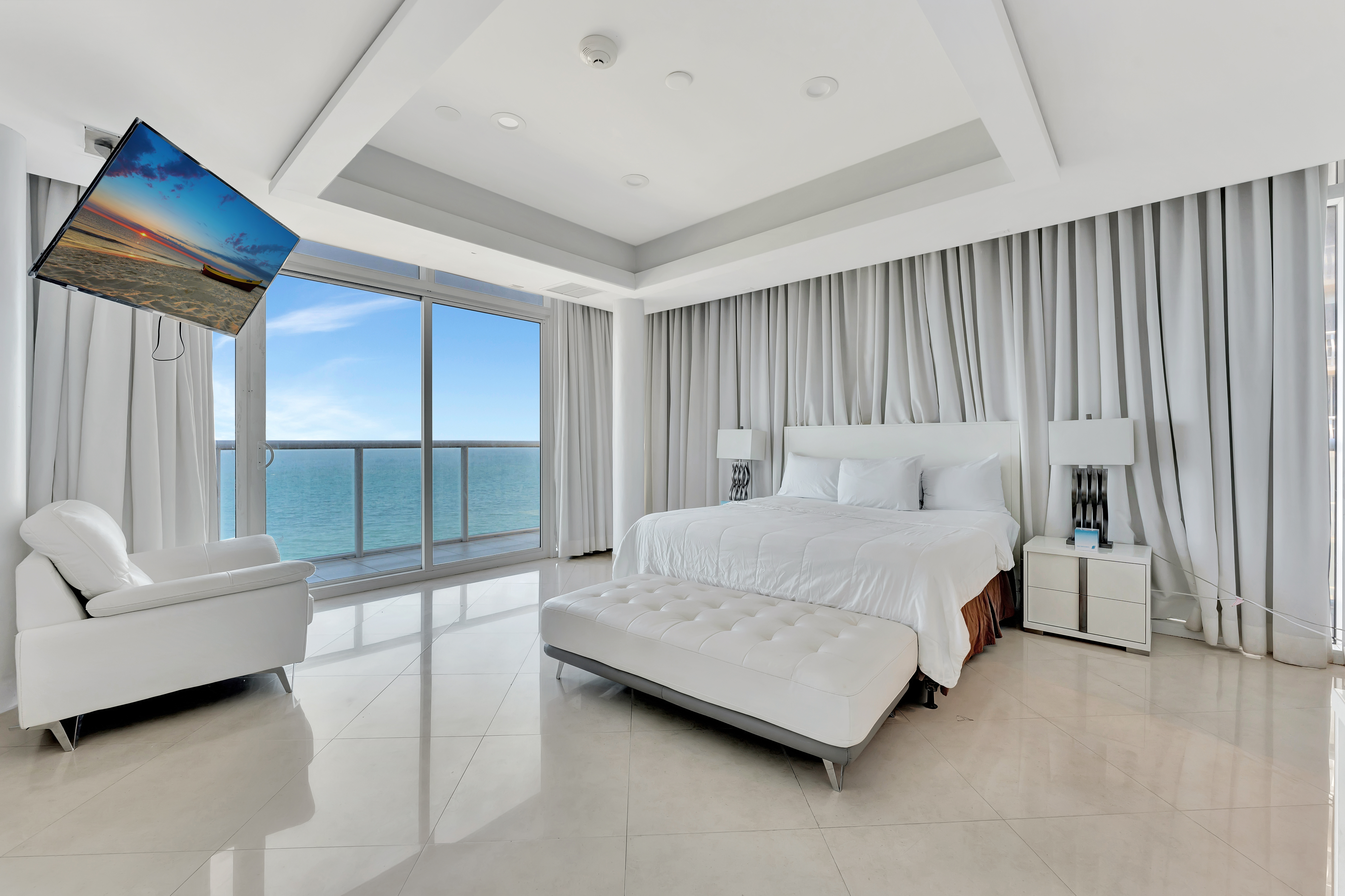 Bedroom in Ocean Manor Penthouse 1102 with elegant white interior and Atlantic Ocean view