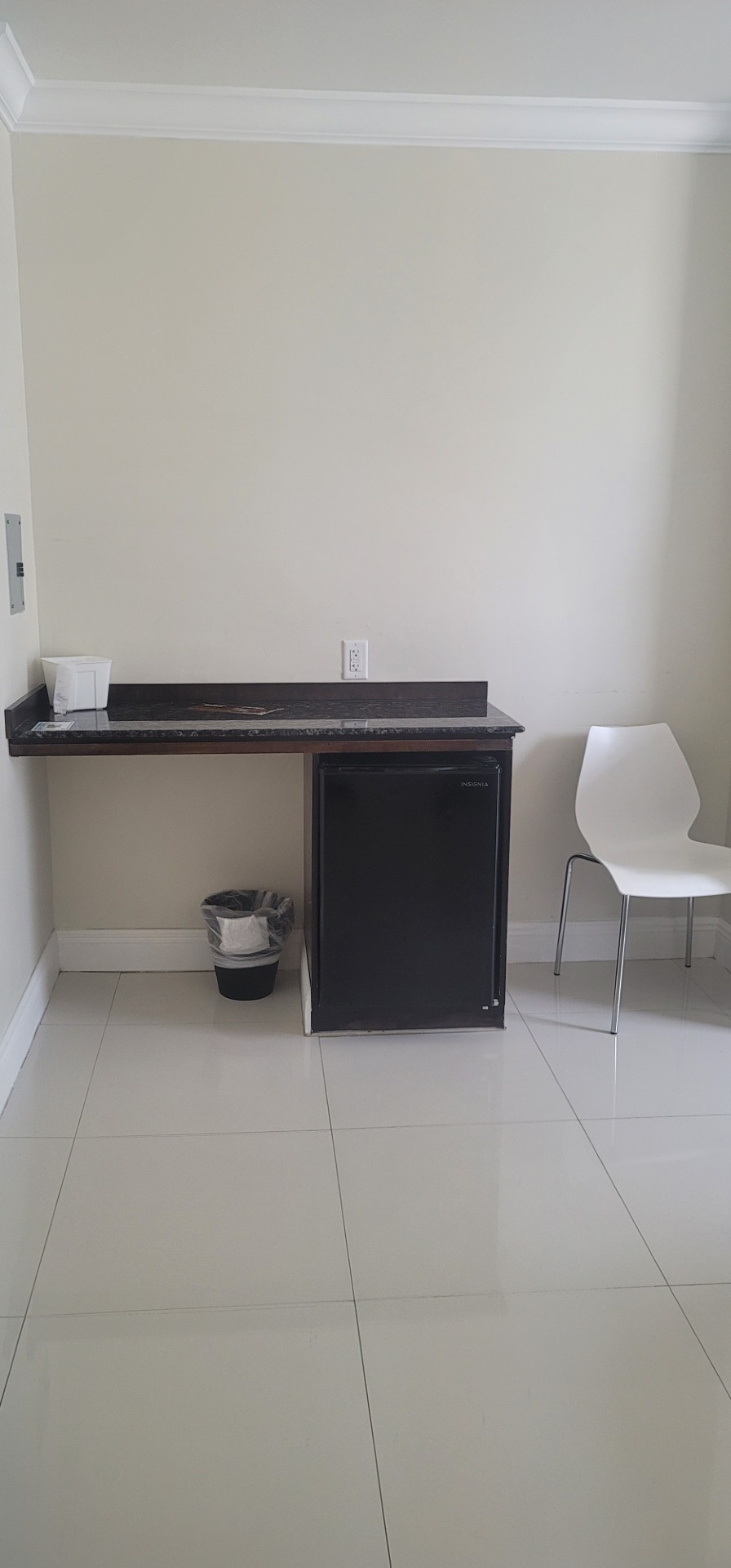 Guest-room kitchenette with a mini fridge and granite countertop