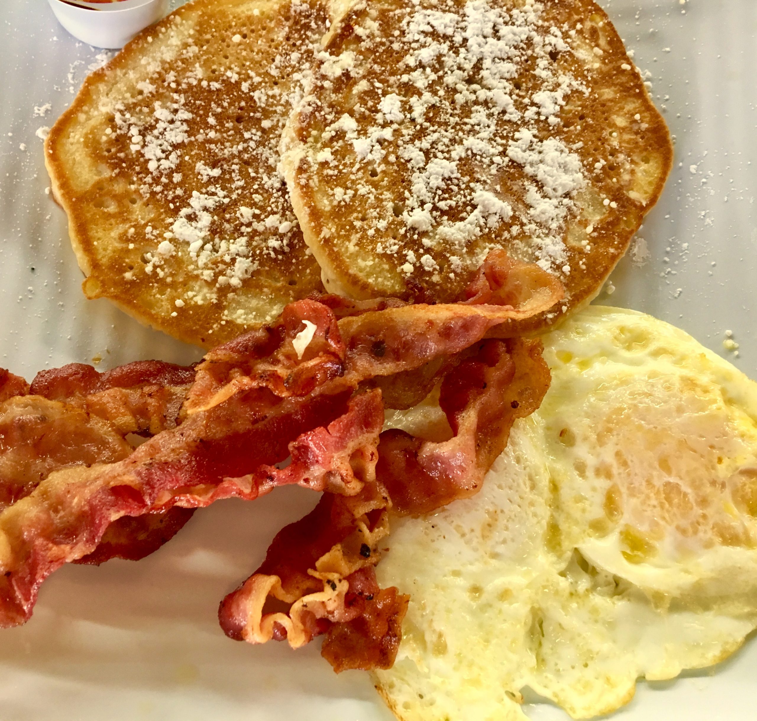 Fried eggs with toast and sausage breakfast plate