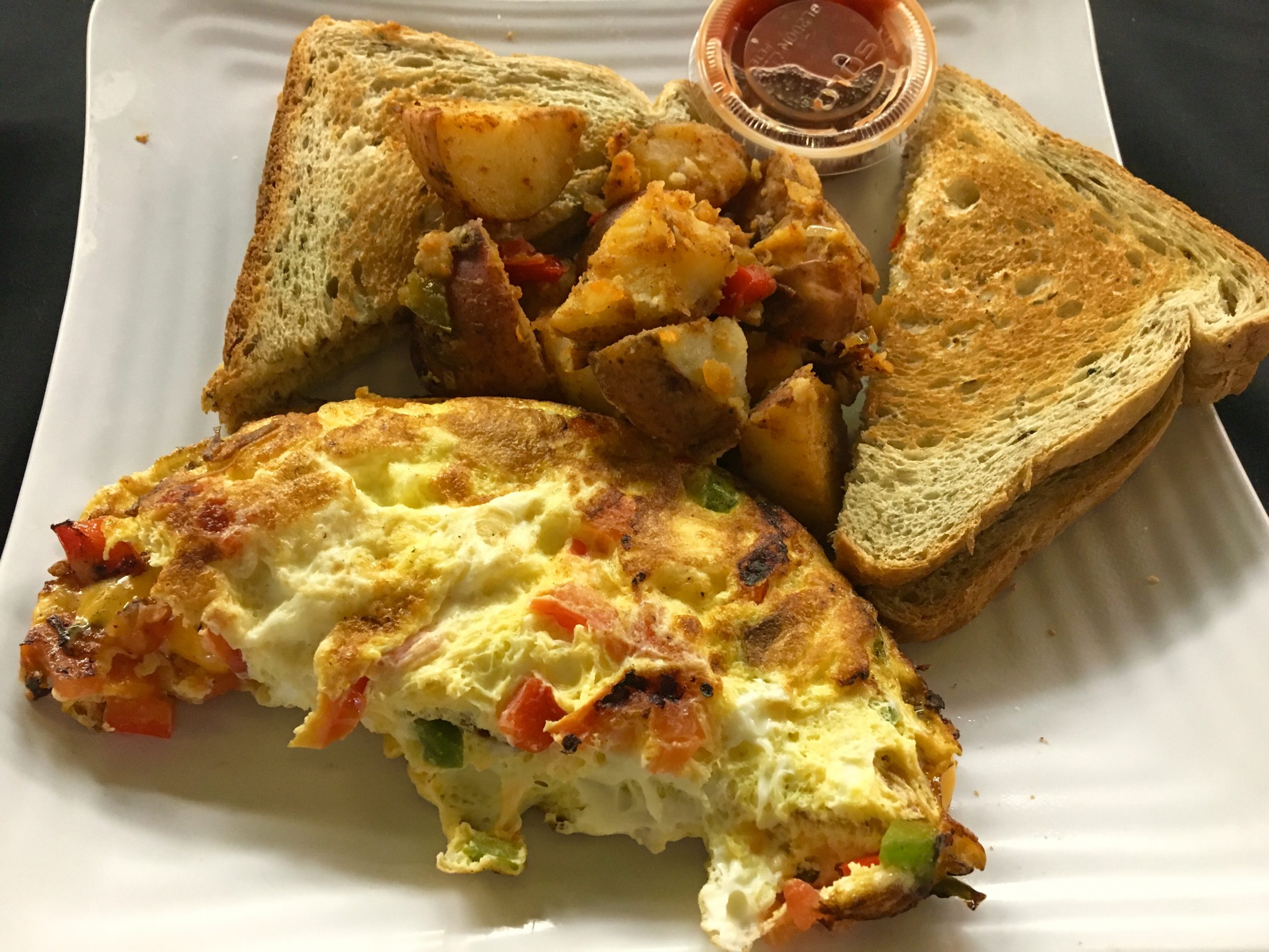 Ocean Manor breakfast with omelette, potatoes, and toast served oceanfront