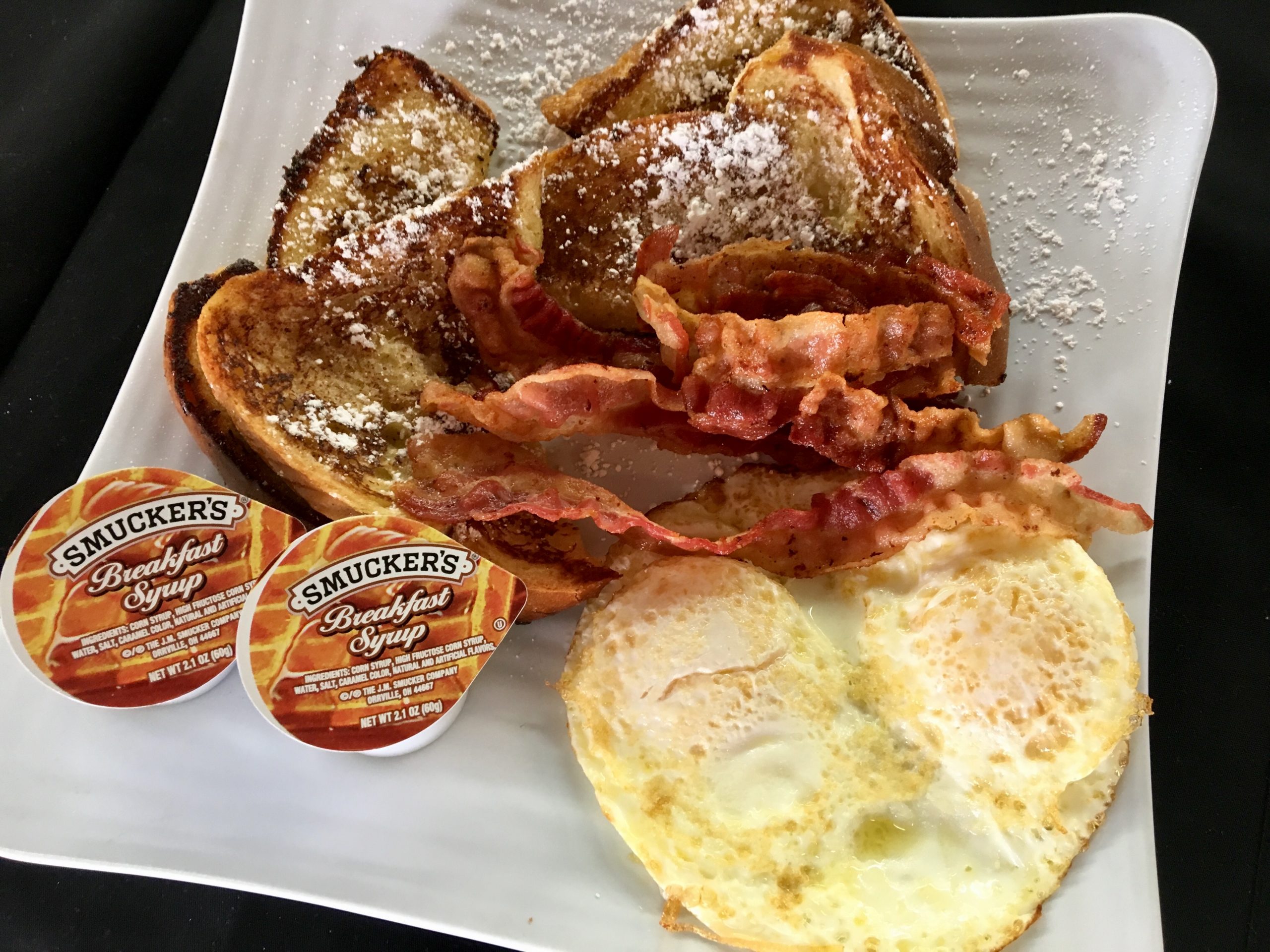 Beachfront pancakes, bacon, and eggs breakfast at Ocean Manor Resort