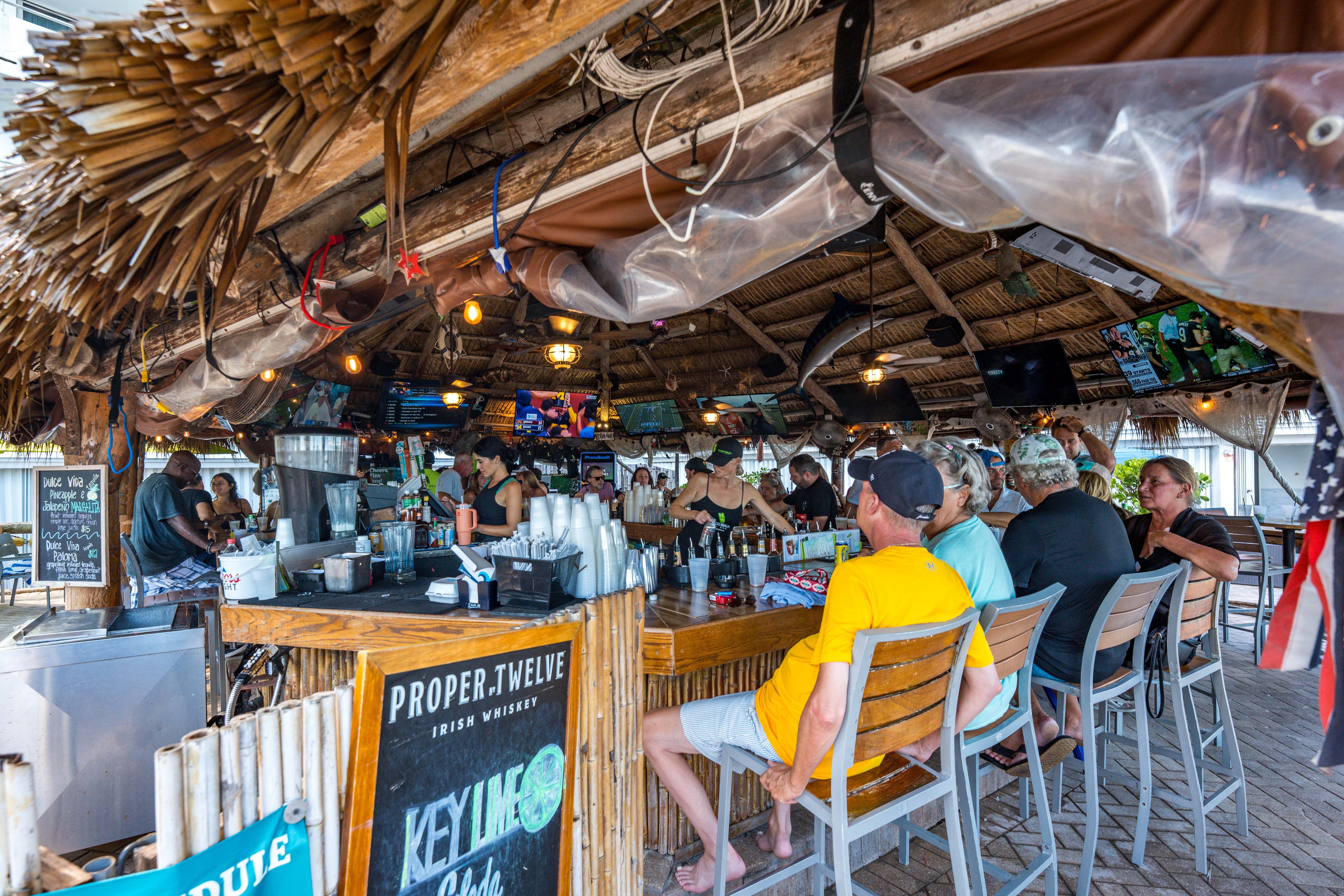 Bamboo Beach Tiki Bar with oceanfront seating, cocktails, and live‑music setting