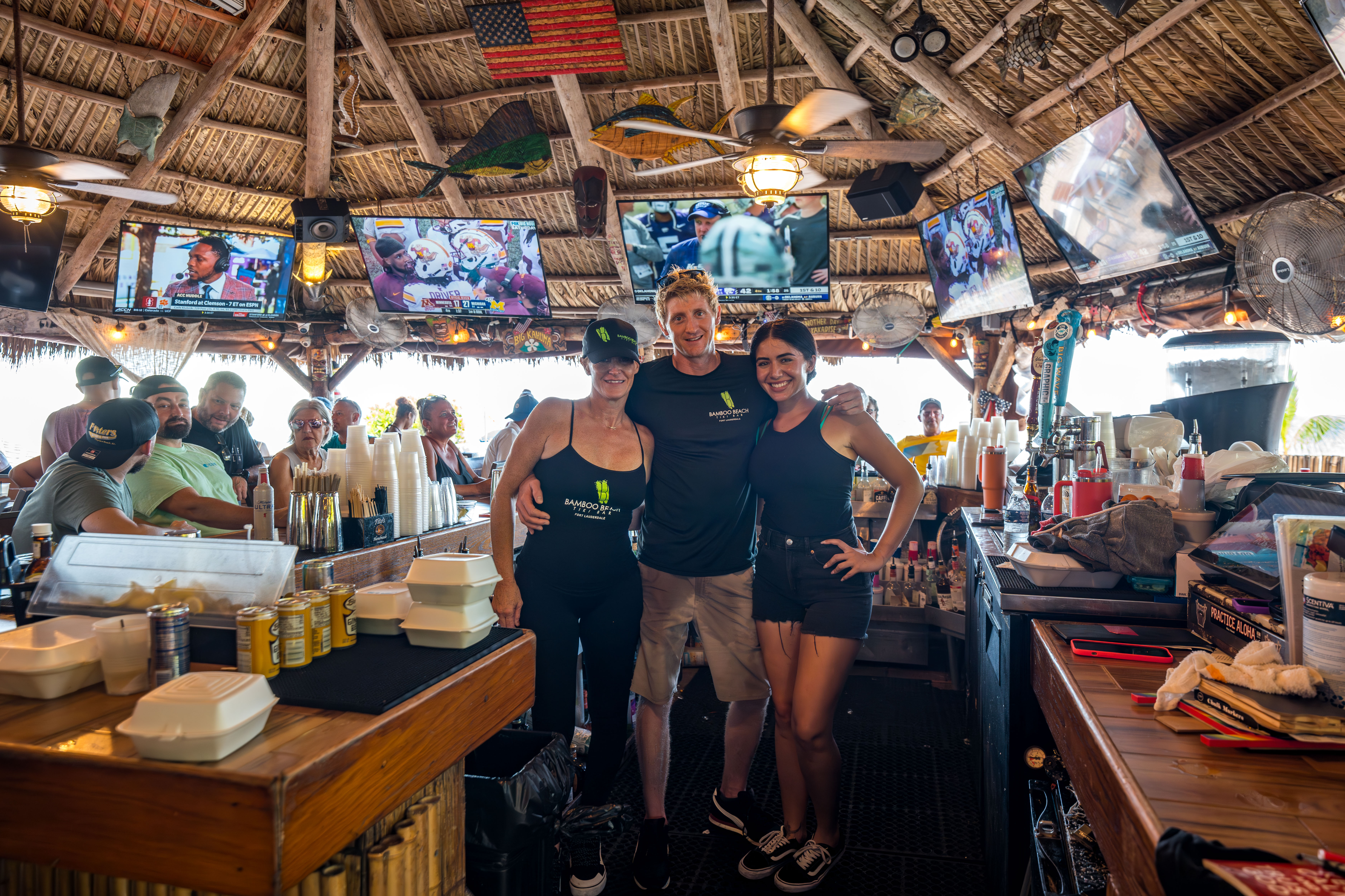 Friendly staff working behind the tiki bar counter