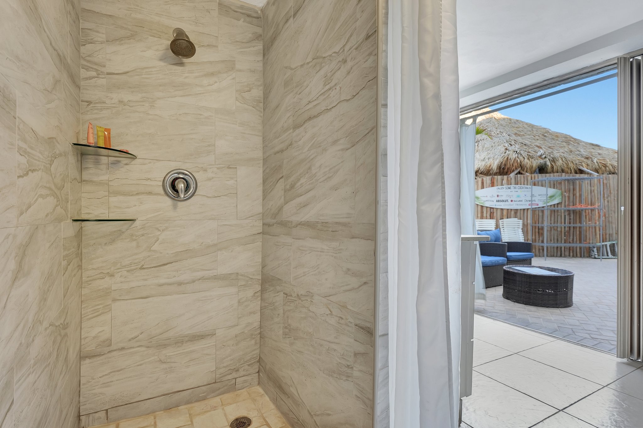 Shower and patio setup in beachfront cabana