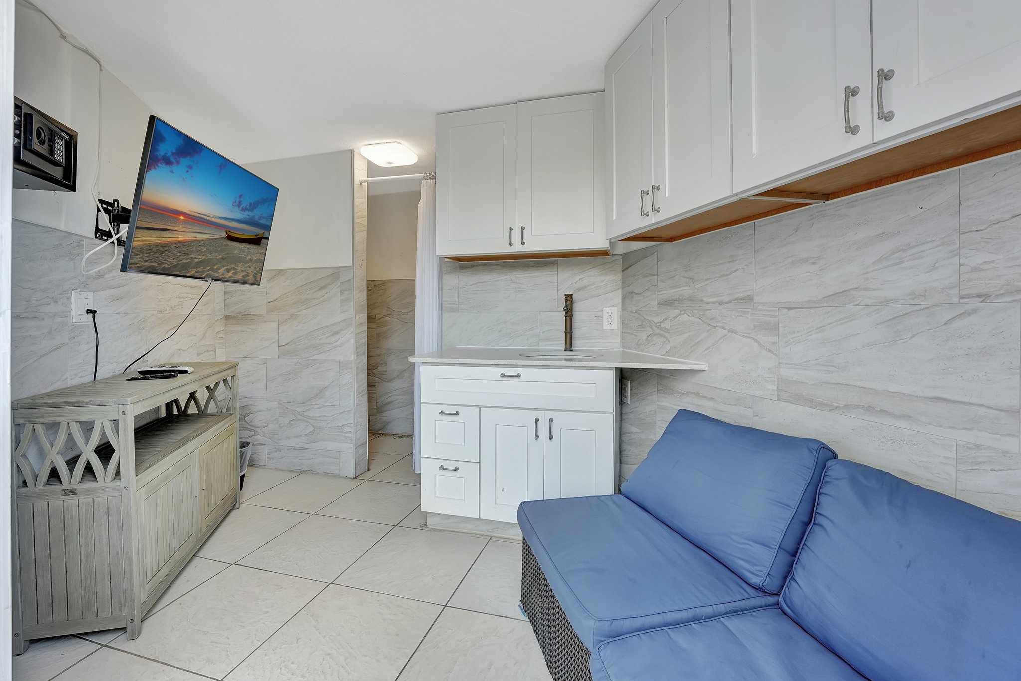 Kitchenette and lounge inside beach cabana at Ocean Manor