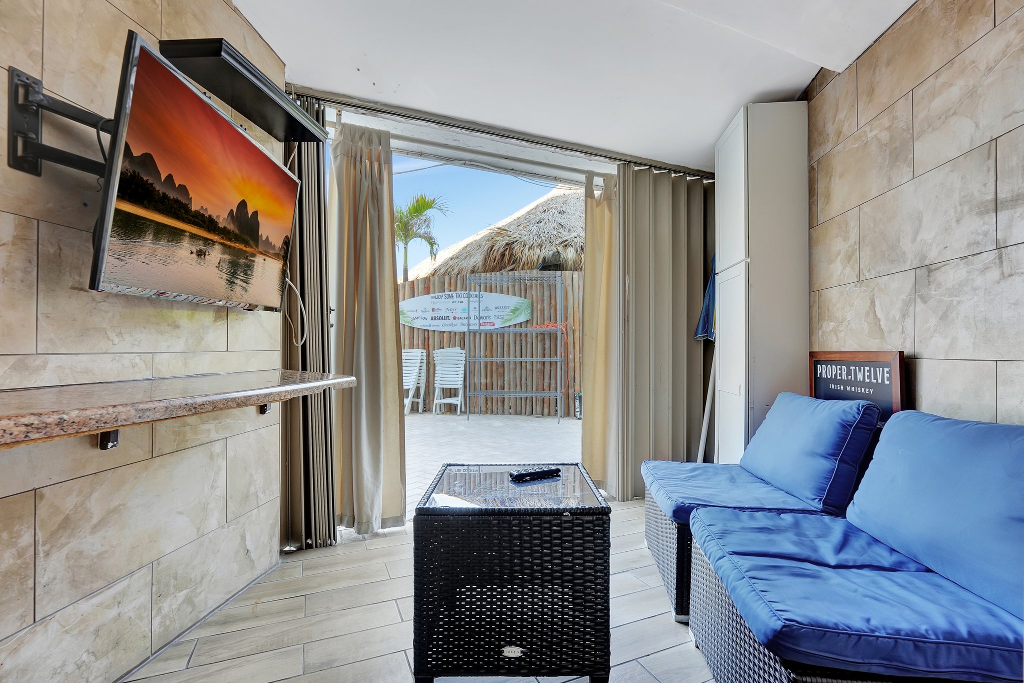 Beach cabana with curtains and flatscreen TV