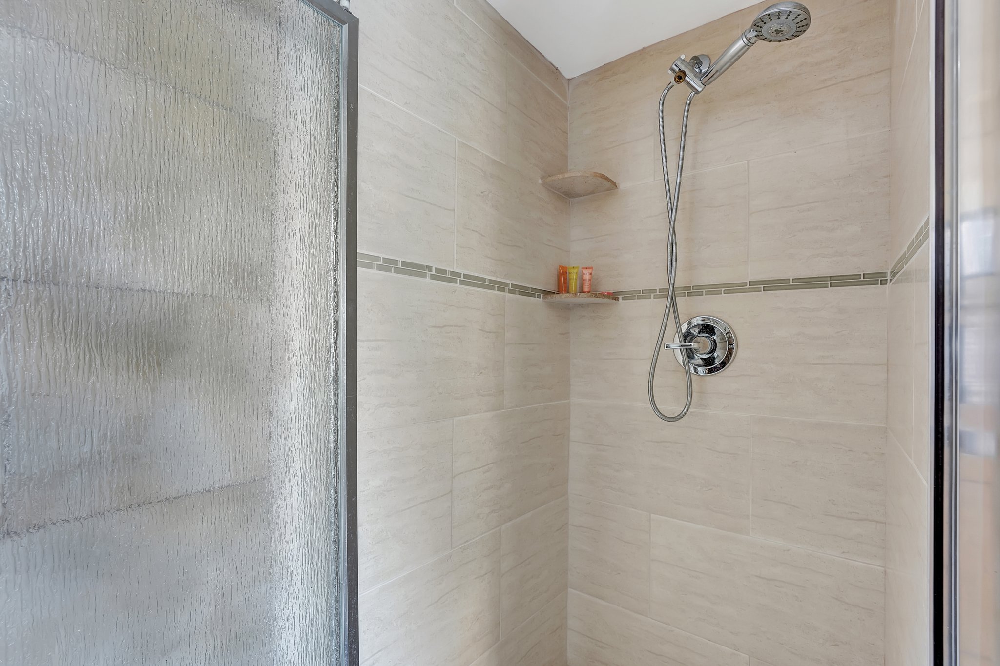 Private cabana bathroom with shower and light tile