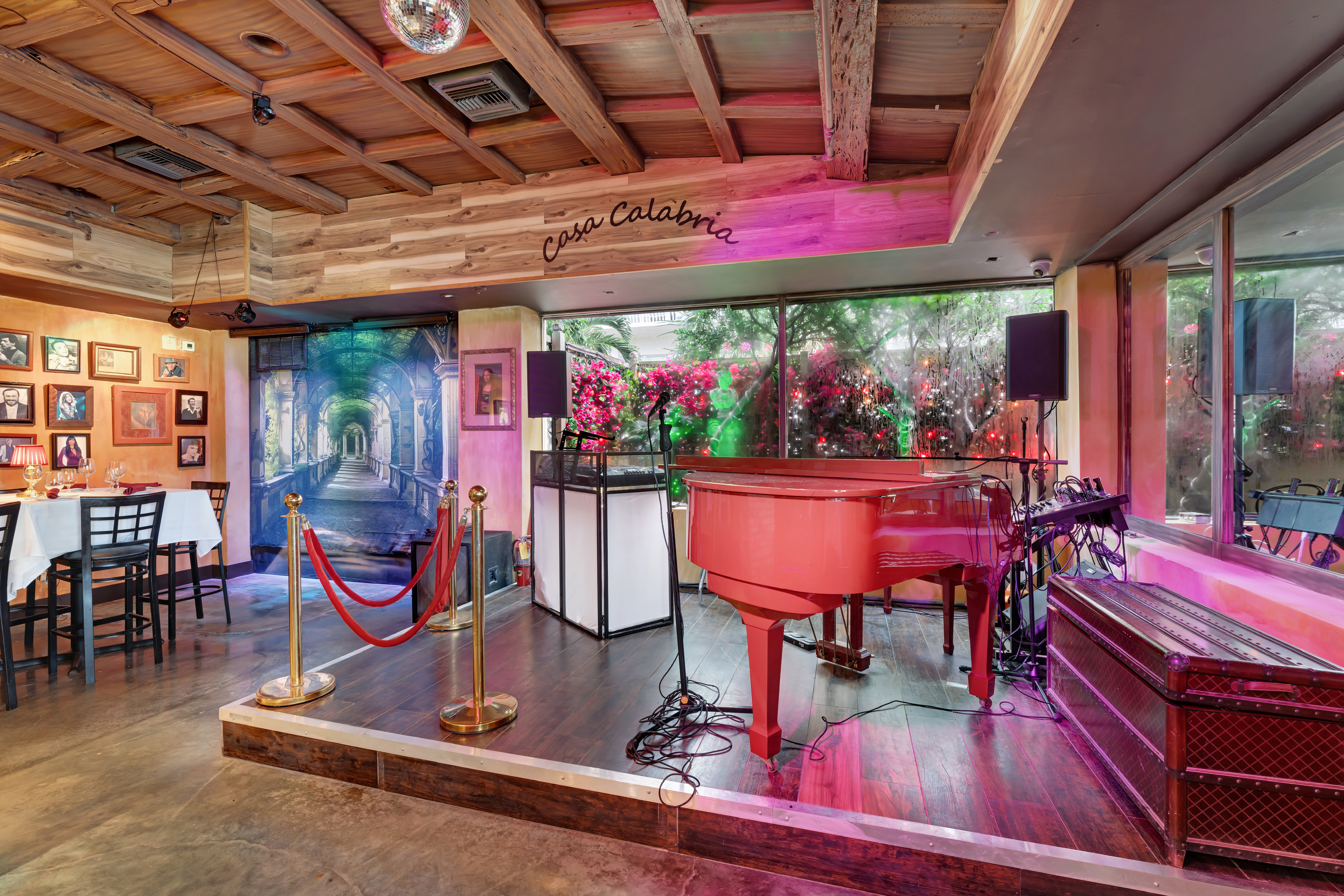 Live piano stage and elegant dining ambiance at Casa Calabria