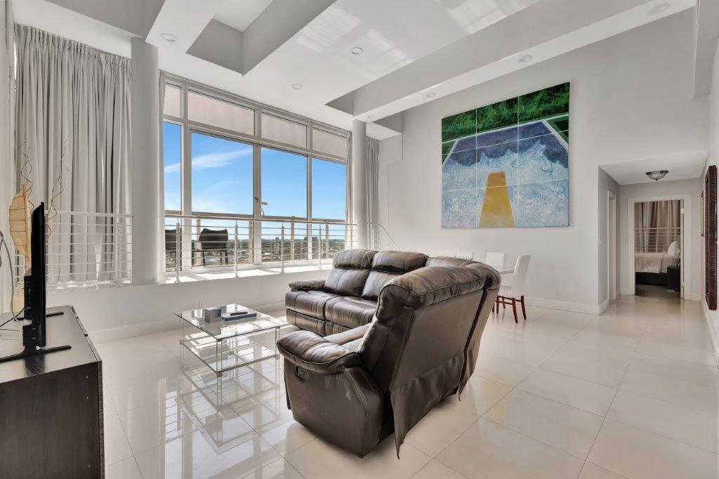 Penthouse 1104 bright living area with high ceilings and skyline view