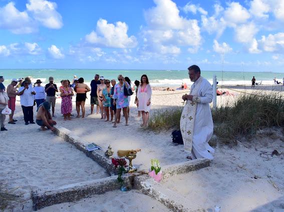 Community gathering by the Miracle Cross on Fort Lauderdale beach