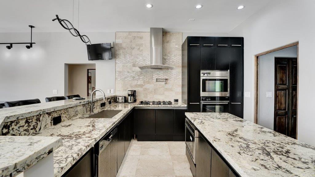 Modern kitchen at 2886 NE 26th Place Fort Lauderdale luxury mansion with granite island and high-end appliances