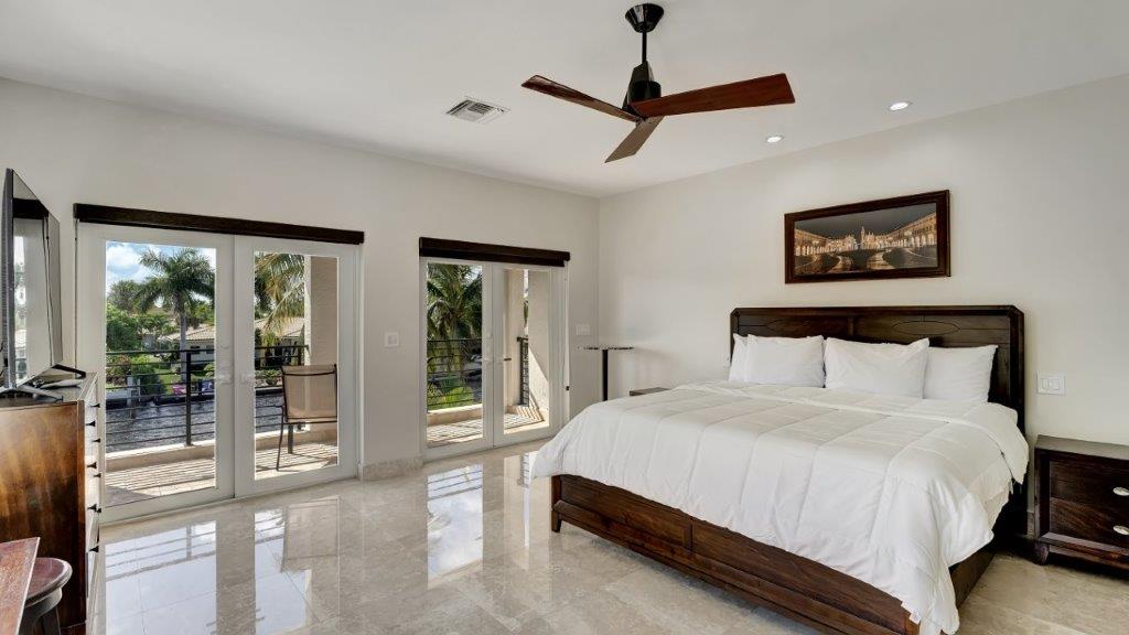 Master bedroom at 2886 NE 26th Place Fort Lauderdale luxury mansion with balcony and waterway view