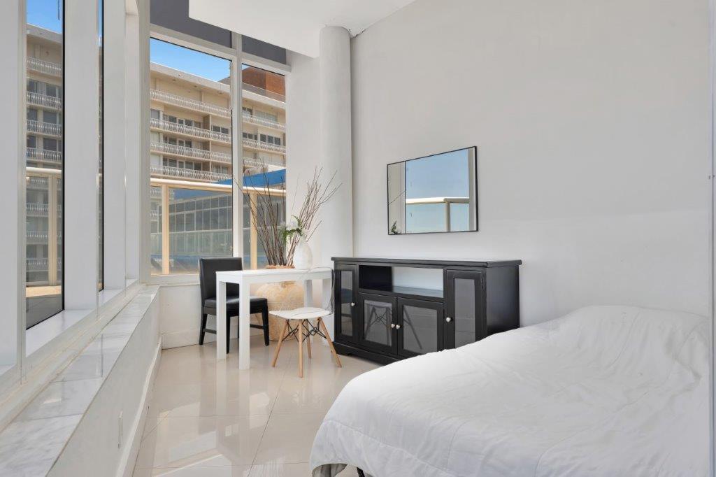 Guest bedroom with natural light and modern furnishings