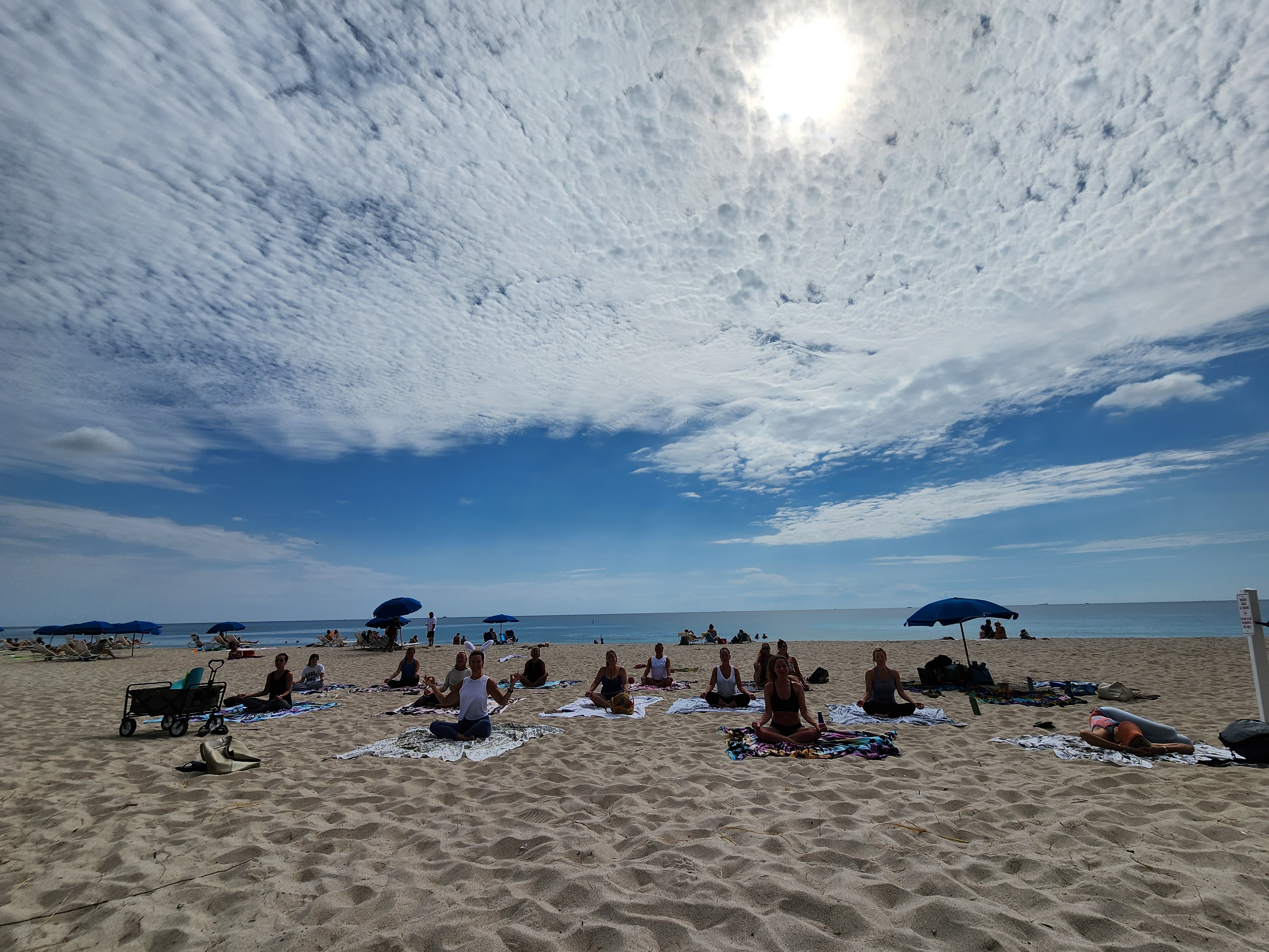 Yoga group class under clear blue sky